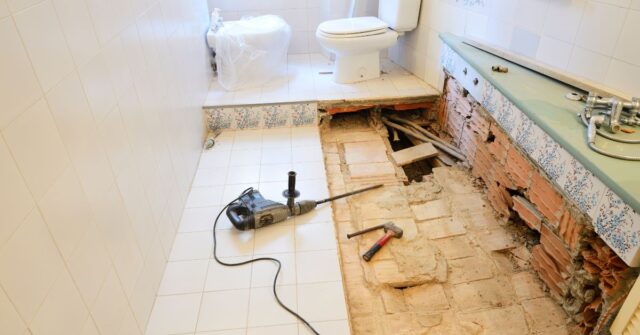 Removing tiles for a bathroom renovation project.