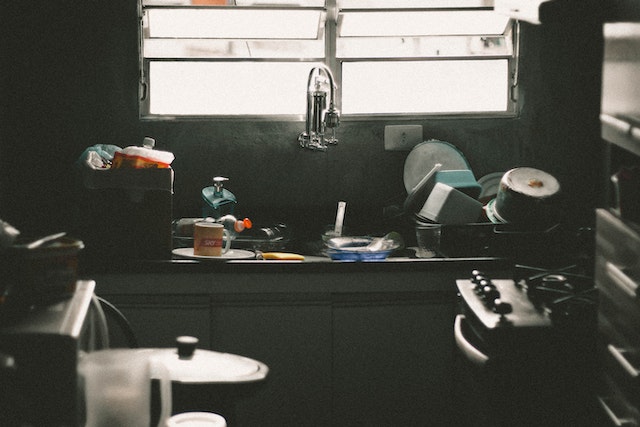 An unorganized, dark & damp kitchen.