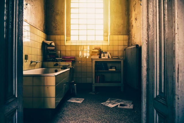 Dark and dirty bathroom with little lightning.