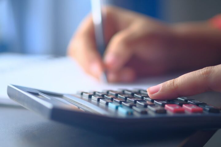 A Person Using a Calculator for renovation budget.