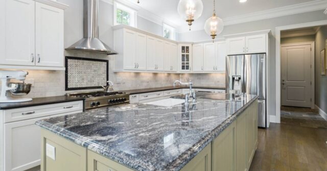 A modern kitchen design with a granite countertop.