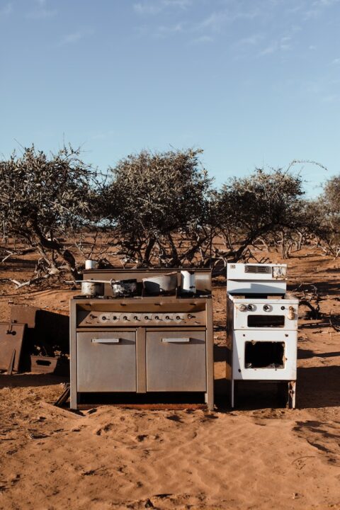 Junk appliances on a dumpster.