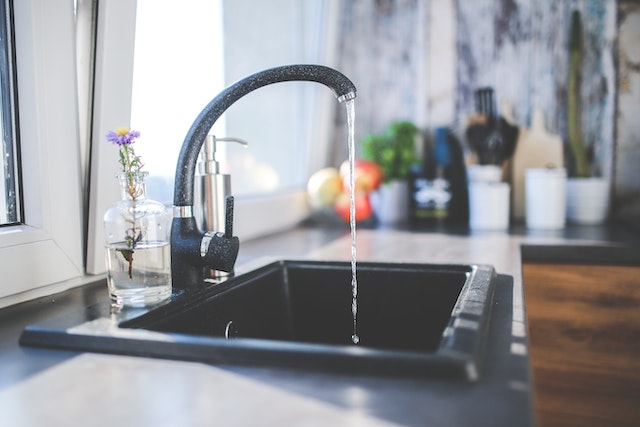 Water flows from the tap to sink.