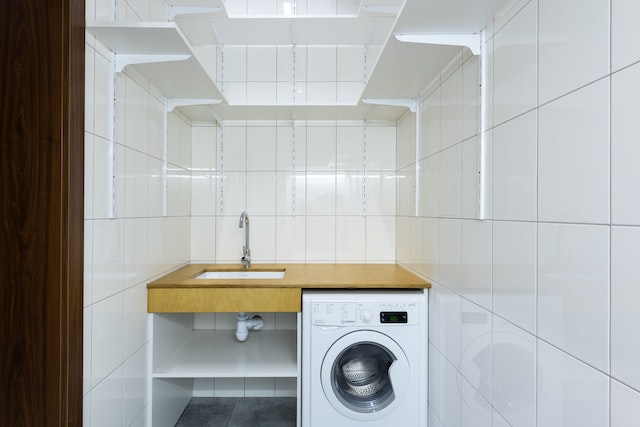 An empty and newly renovated small laundry area.