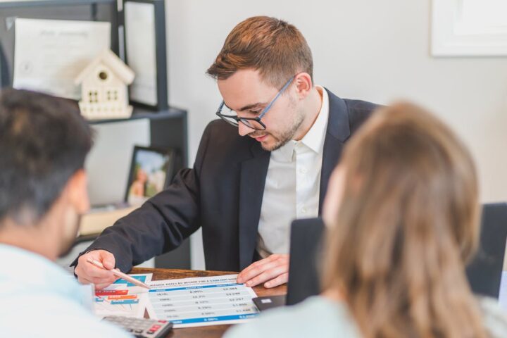Loan Agent Discussing in Front of His Client