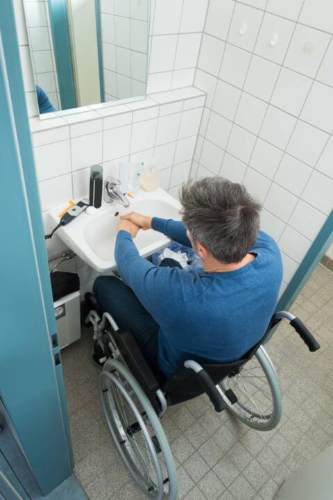 A bathroom with a sink thhat is accessible for wheelchairs.
