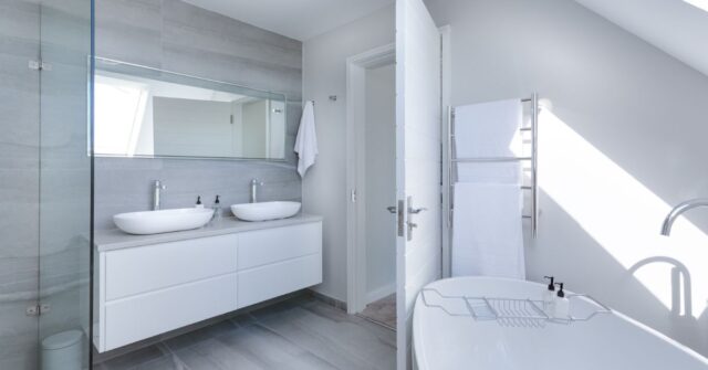 Modern minimalist bathroom in gray and white color palette.