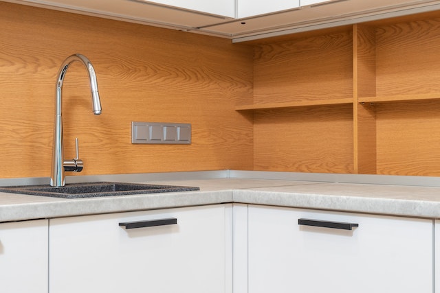 Cabinet with tap above sink in contemporary kitchen.