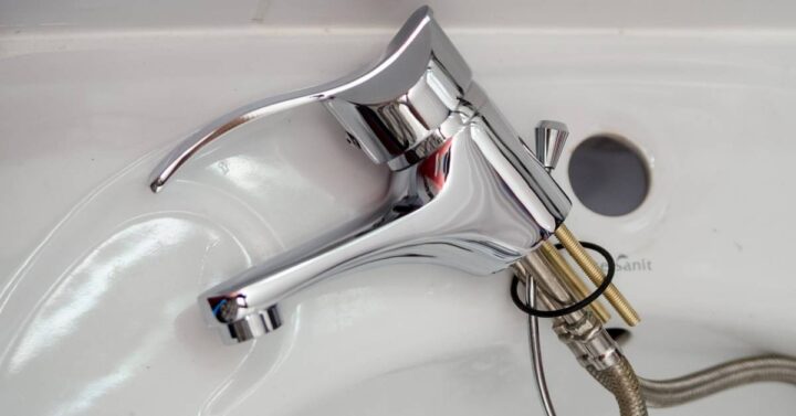 New uninstalled faucet lying on a sink.