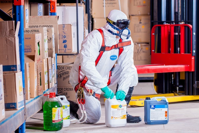 A person wearing a protective gear while handling chemicals.