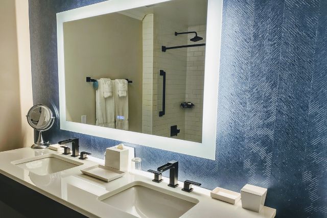 A huge and hi-tech smart mirror in a hotel bathroom.