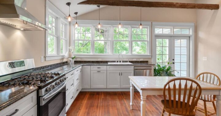 A spacious wooden kitchen with energy saving appliances.
