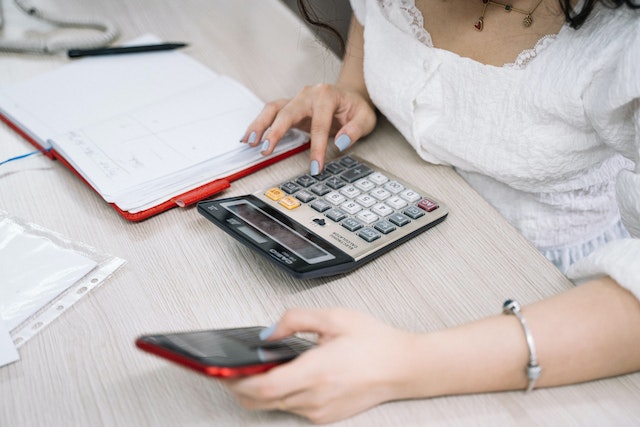 A woman working on a calculation for bathroom renovation.