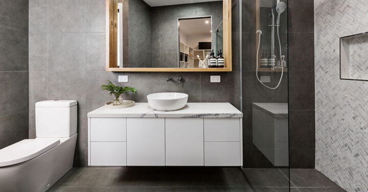 Stylish bathroom with vanity, toilet and open shower