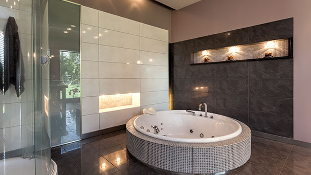 Large built in spa bath in ultra modern designer bathroom.