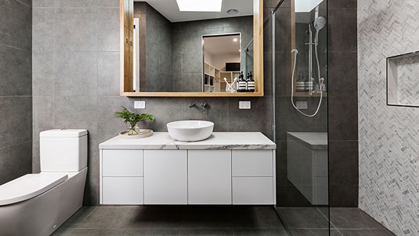 Stylish bathroom with vanity, toilet and open shower