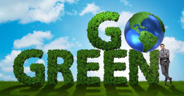 3D rendering of large letters saying Go Green in green leafy foliage with a blue sky in the background.