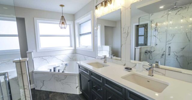 A very luxurious bathroom with marble tiles and big bathtub.