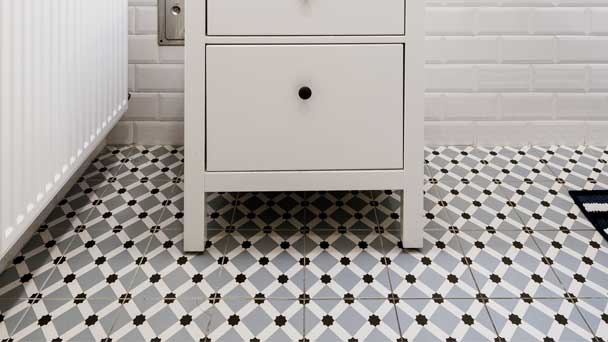 A traditional bathroom design with mosaic type of floor tiles.