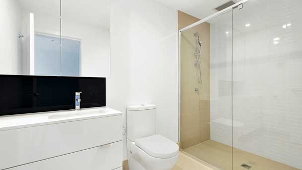 A clean looking bathroom with semi framed glass shower screen.