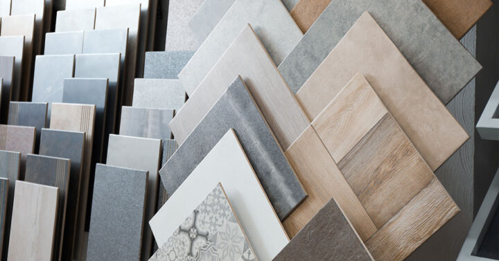 Variety of ceramic and porcelain floor and wall tiles in different colors, textures, and finishes displayed in a showroom.